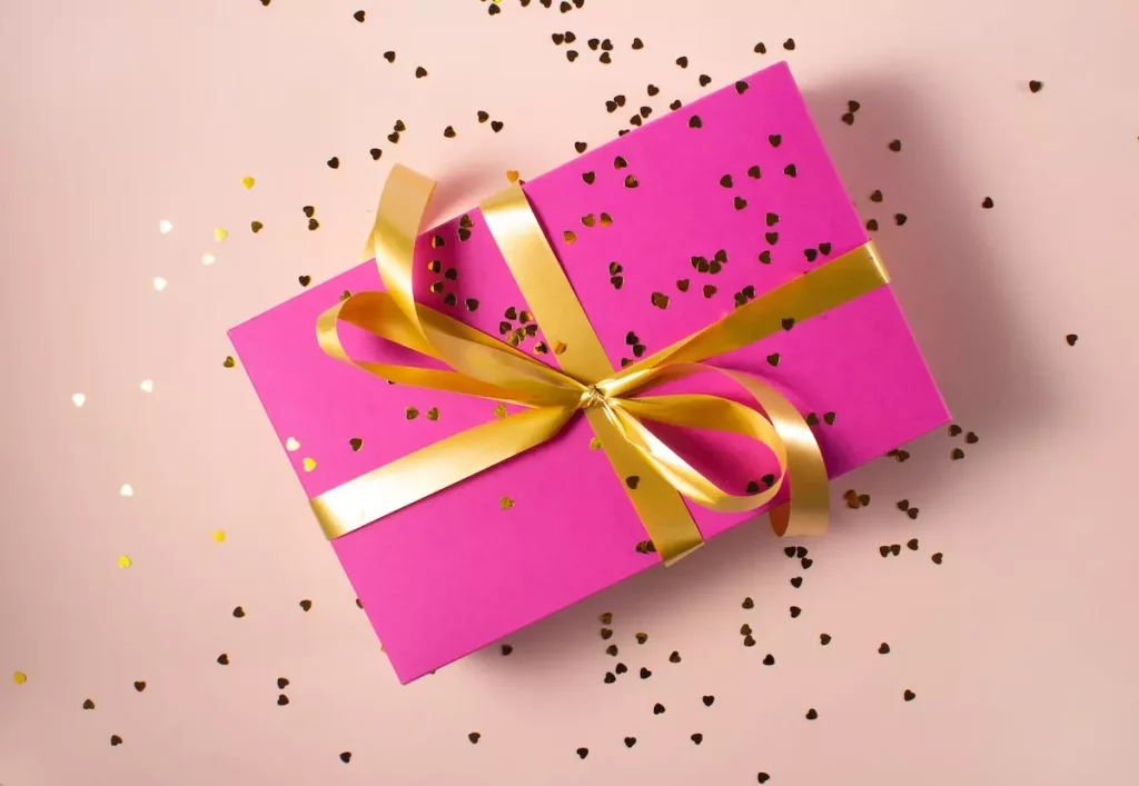 pink gift box, gold ribbon