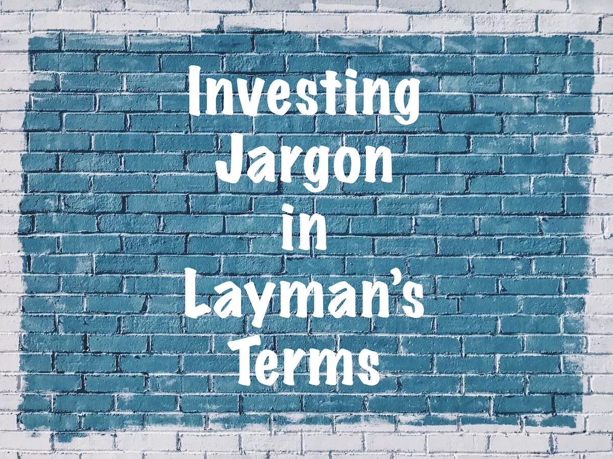 'investing jargon in layman's terms' on a blue brick wall