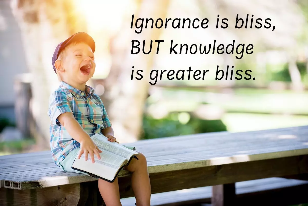 boy happily reading on a bench - quote: knowledge is greater bliss
