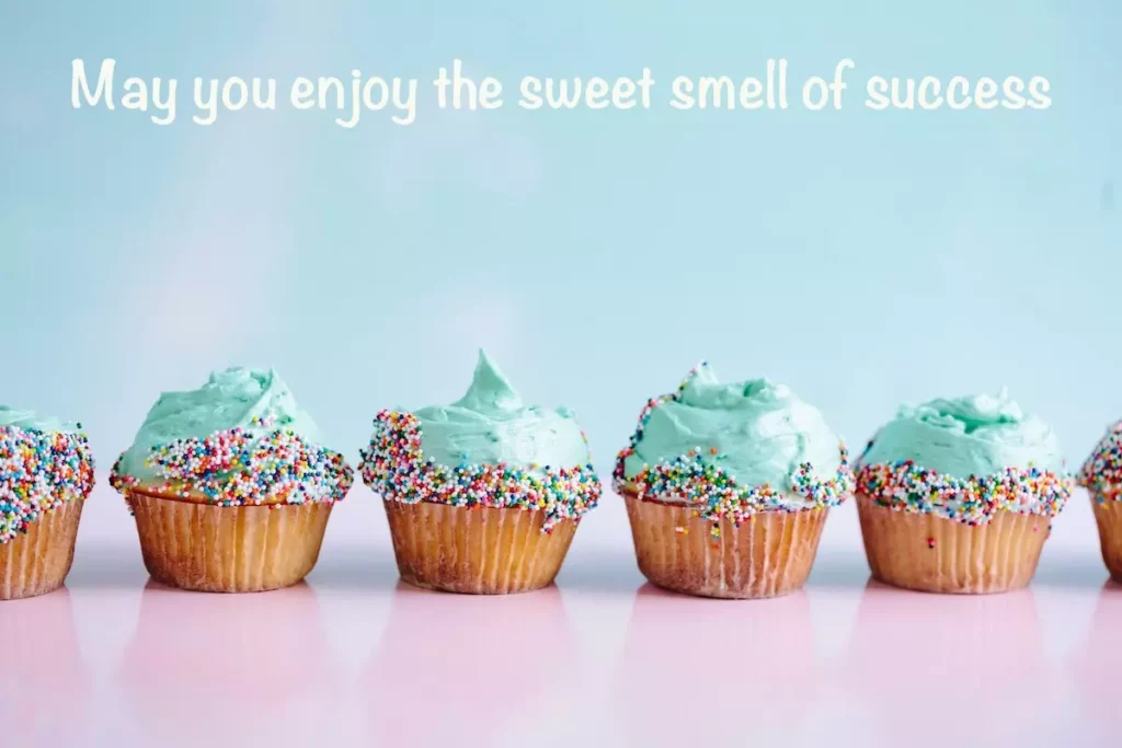 row of cupcakes with 'may you enjoy the sweet smell of success' best wishes