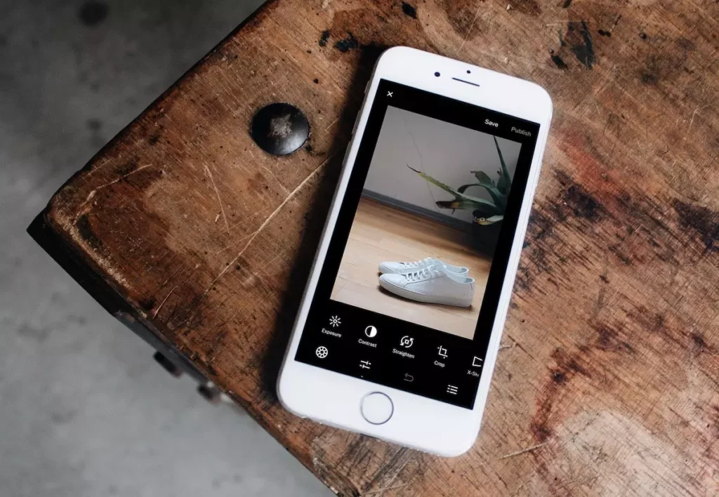 Mobile phone shopping app showing a pair of white sneakers