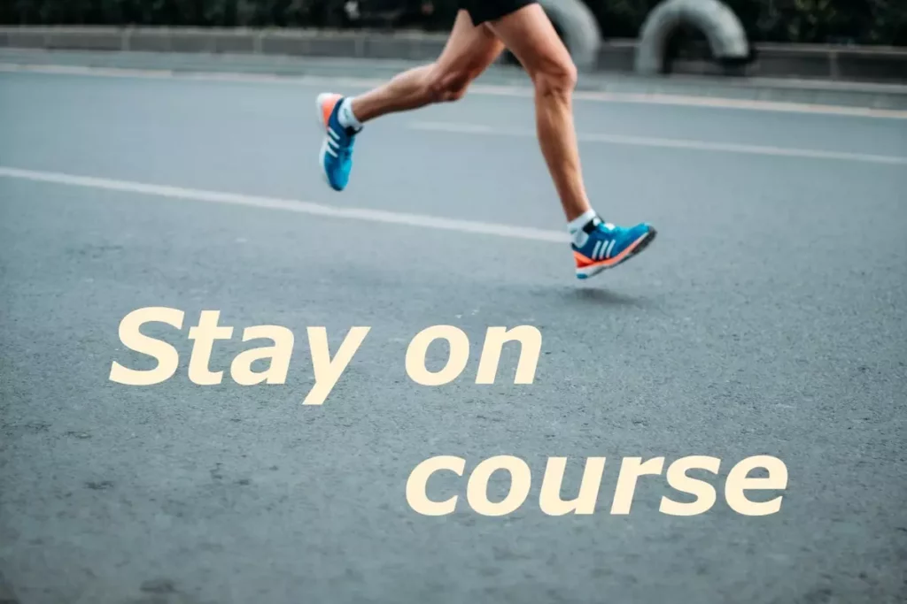 Image of runner's legs, running on the road with the quote: stay on course.