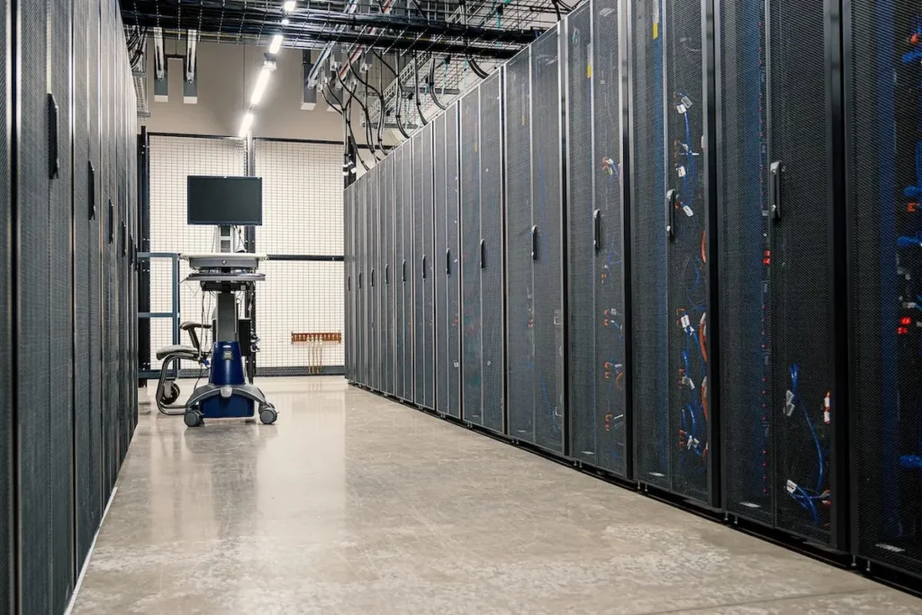 Image of data centre with 2 rows of server racks.