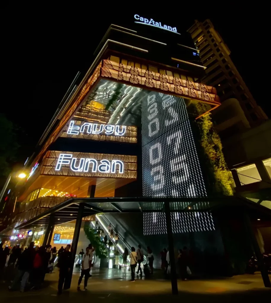 Image of Funan Mall with the CapitaLand logo in neon at the top of the building.