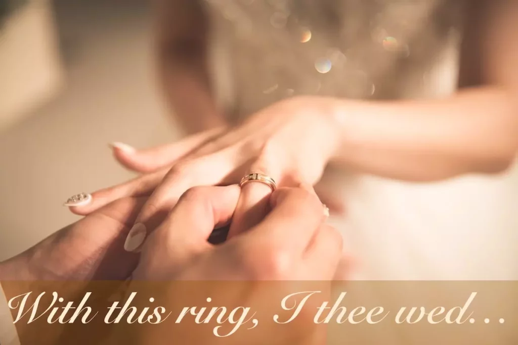 Image of groom slipping the wedding band onto the ring finger of the bride with the text overlay: With this ring, I thee wed...