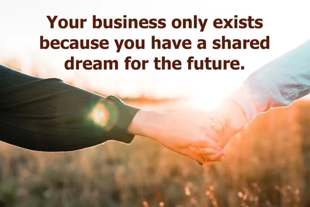 Image of couple holding hands into the sunset with the text overlay: Your business only exists because you have a shared dream for the future.