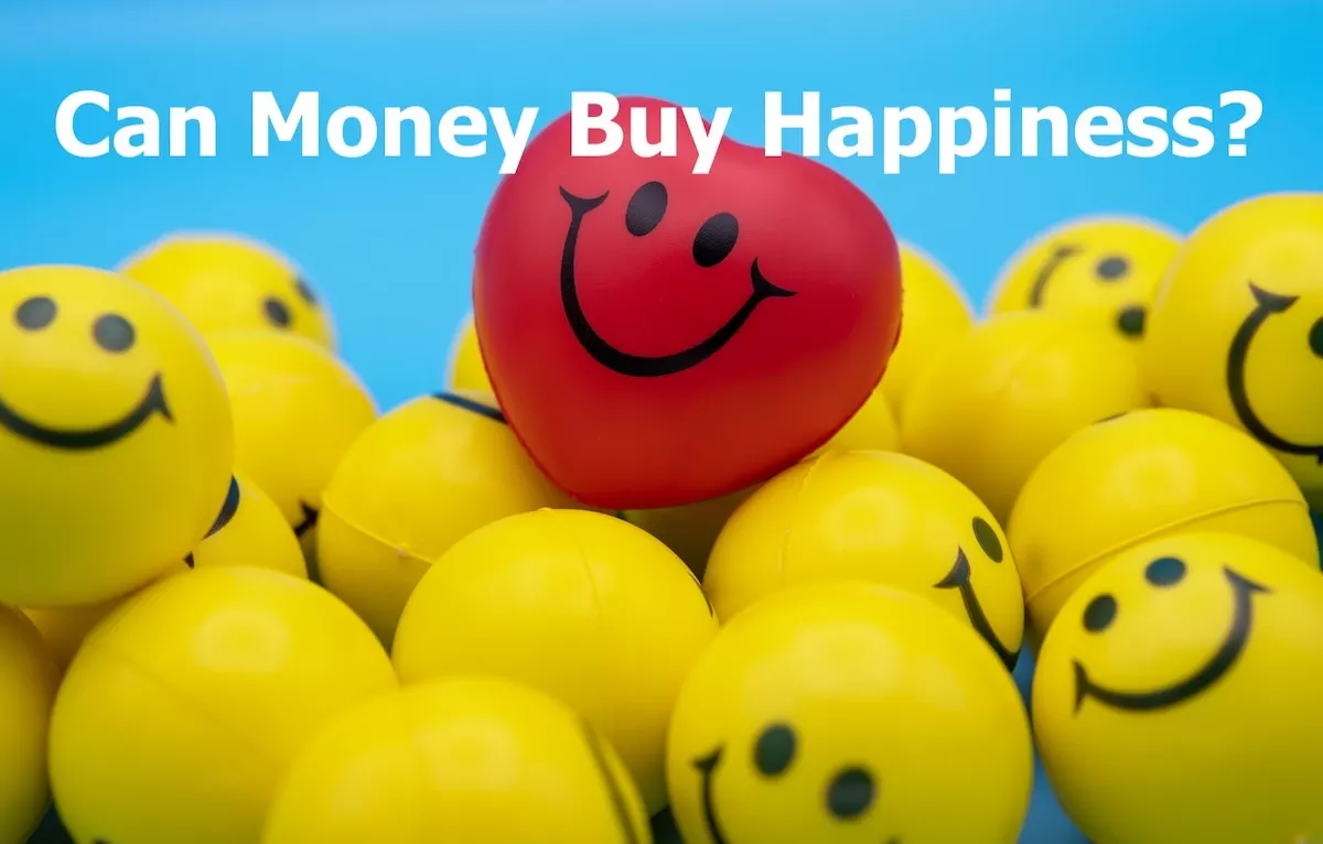 Image of a bunch of smiley faced yellow rubber balls with the text overlay: can money buy happiness?