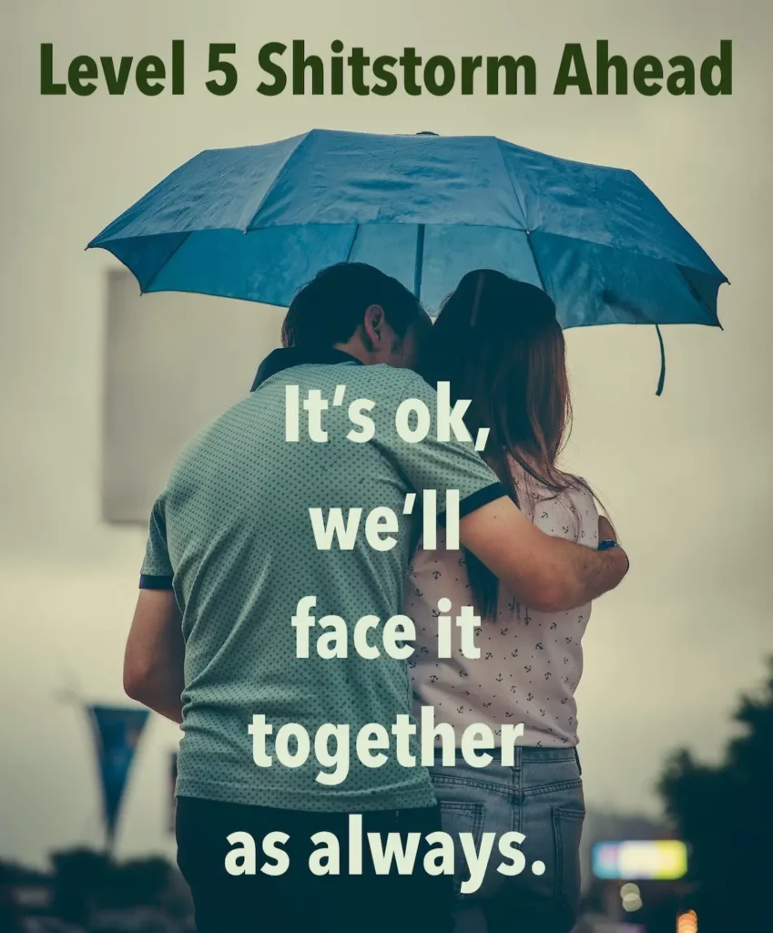 Image of couple huddled under an umbrella with the text overlay: Level 5 Shitstorm ahead. It's ok, we'll face it together as always.