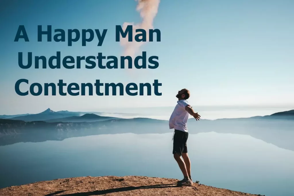 Image of a man standing in front of a scenic lake with his arms spread open with the text overlay: a happy man understands contentment.