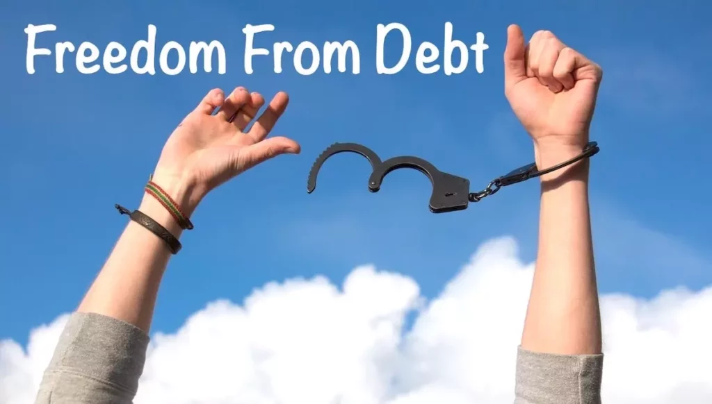 Image of a pair of hands raised to the sky, released from hand cuffs with the text overlay: Freedom from Debt.