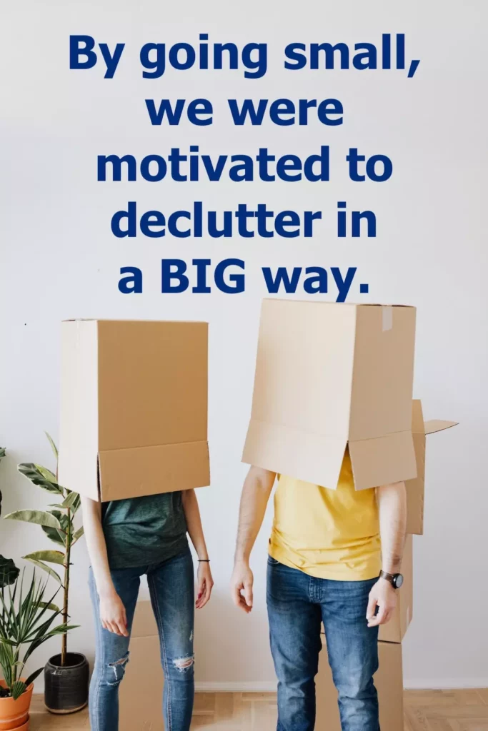 Image of a couple with boxes over their heads with text overlay: By going small we were motivated to declutter in a big way.