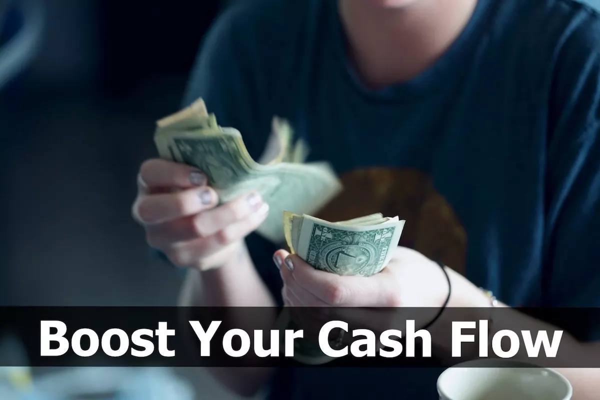 Image of person counting dollar bills with the text overlay: Boost your cash flow.