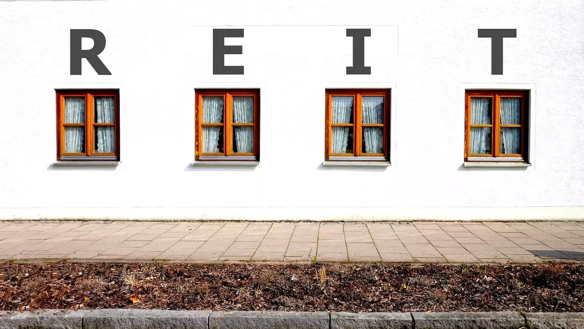 The acronym R-E-I-T written above four windows